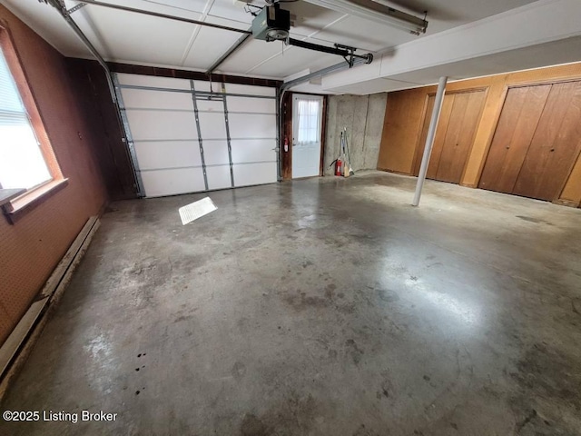 garage featuring baseboard heating and a garage door opener