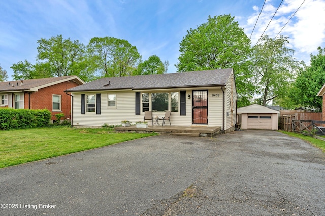 ranch-style house with a porch, fence, aphalt driveway, an outbuilding, and a front yard