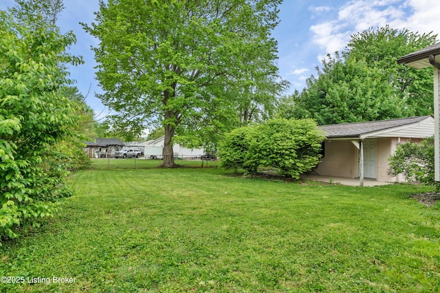view of yard featuring a patio and fence
