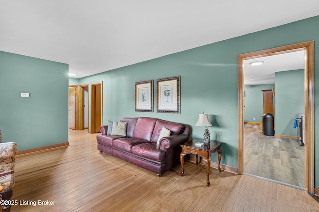 living room with baseboards and wood finished floors