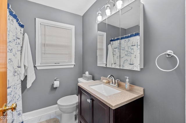 full bathroom featuring toilet, vanity, and baseboards