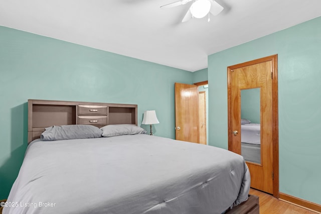 bedroom featuring ceiling fan, wood finished floors, and baseboards
