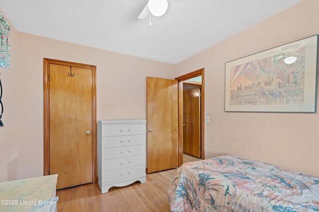 bedroom with a ceiling fan and light wood-type flooring