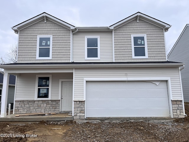 view of front facade with a garage and covered porch