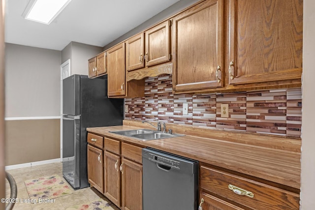 kitchen featuring appliances with stainless steel finishes, sink, light tile patterned floors, and backsplash