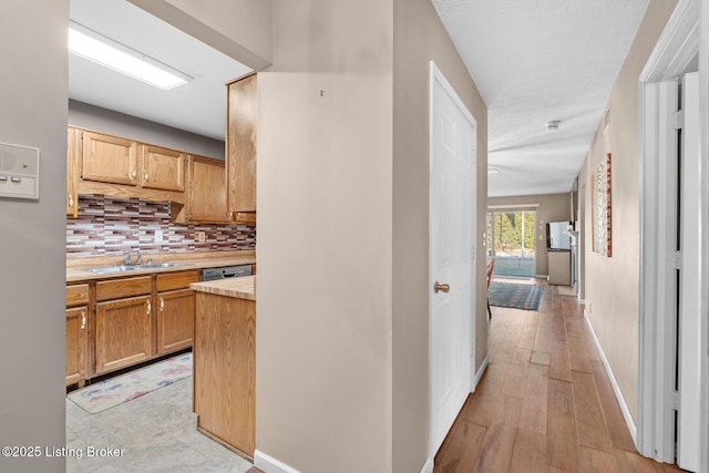 hall with sink and light hardwood / wood-style flooring