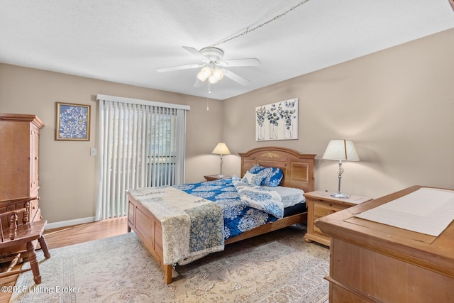 bedroom with access to exterior, ceiling fan, and light hardwood / wood-style flooring