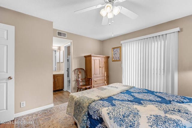 bedroom featuring connected bathroom, light hardwood / wood-style floors, and ceiling fan