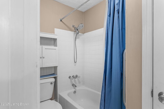 bathroom featuring shower / tub combo with curtain, toilet, and a textured ceiling