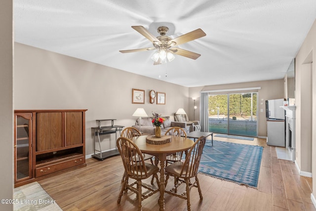 dining space featuring light hardwood / wood-style floors and ceiling fan