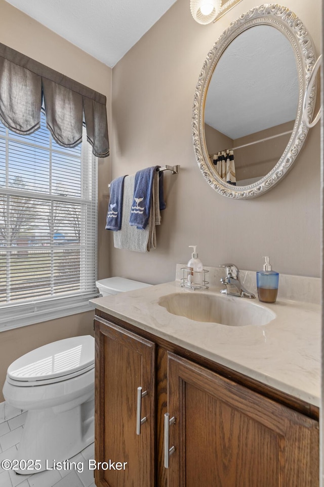 bathroom featuring vanity, curtained shower, tile patterned floors, and toilet