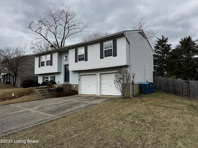 bi-level home featuring a garage and a front yard