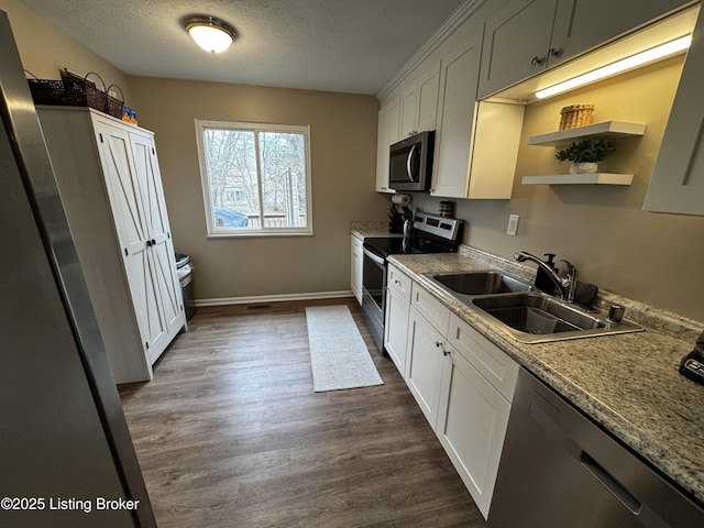 kitchen with white cabinetry, appliances with stainless steel finishes, and sink