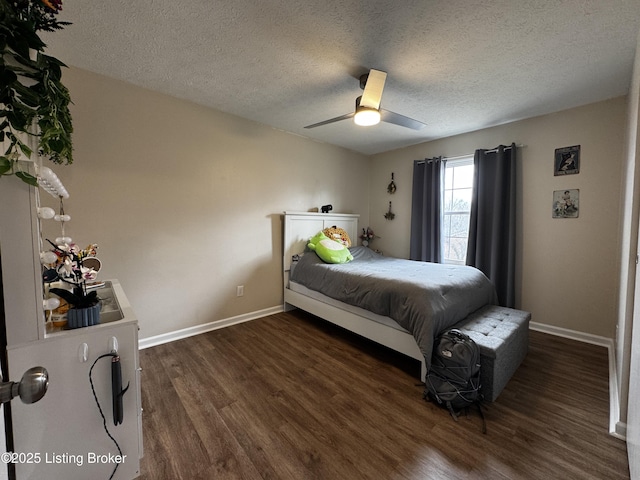 bedroom featuring ceiling fan, a textured ceiling, and dark hardwood / wood-style flooring