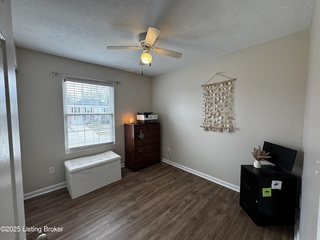 interior space featuring ceiling fan, dark hardwood / wood-style flooring, and a textured ceiling