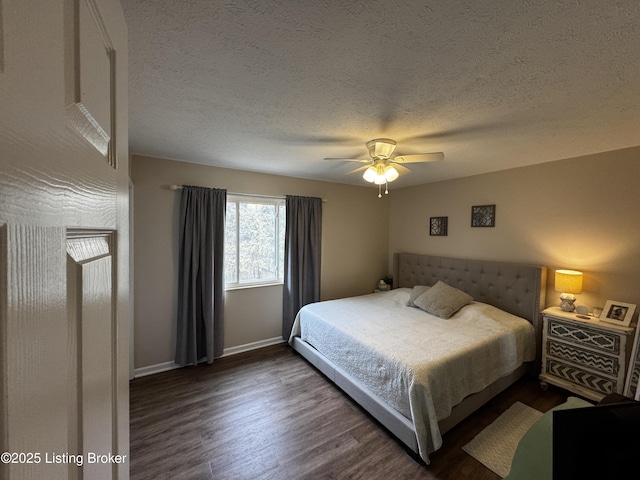 bedroom featuring ceiling fan, dark wood-type flooring, and a textured ceiling