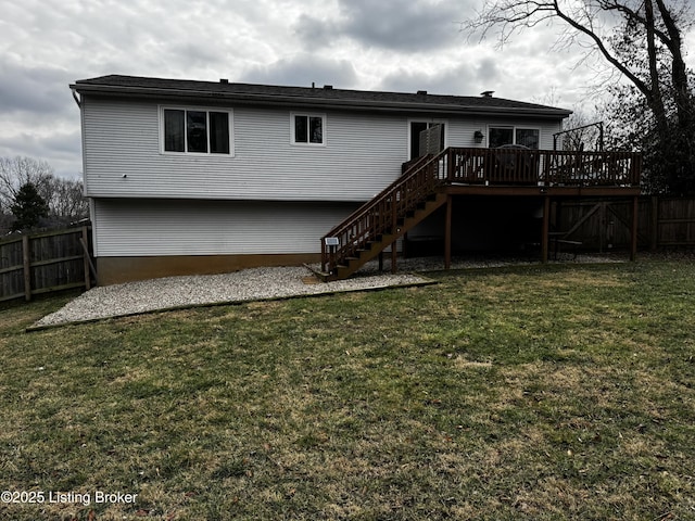 back of property with a lawn and a deck