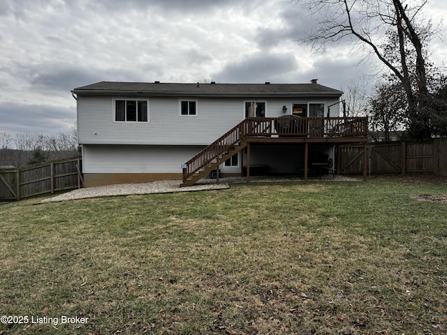 rear view of property featuring a yard and a deck