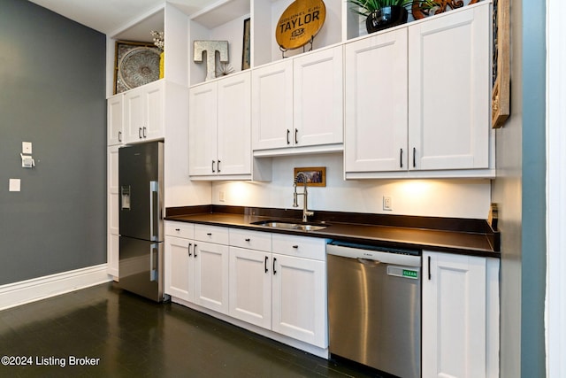 kitchen with white cabinetry, stainless steel appliances, dark wood-type flooring, and sink