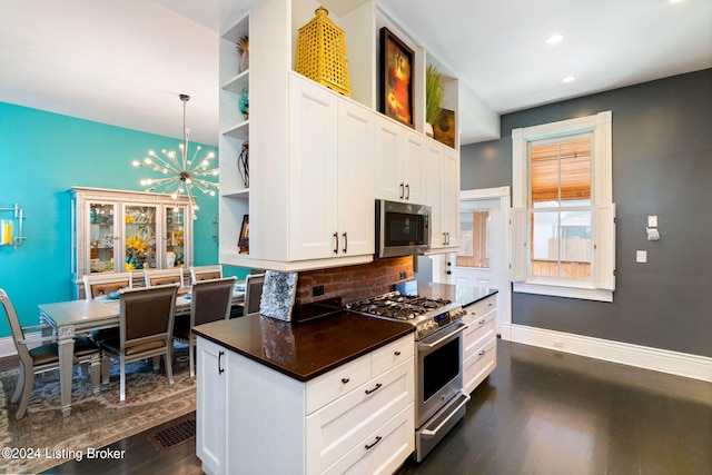 kitchen with white cabinetry, dark wood-type flooring, a chandelier, and appliances with stainless steel finishes