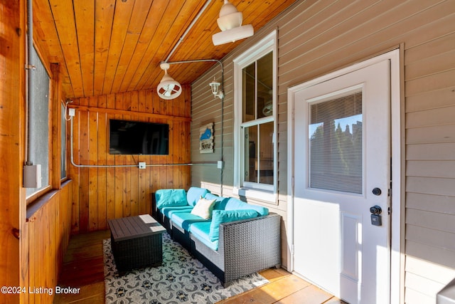 sunroom with lofted ceiling and wood ceiling