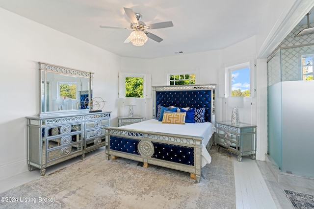 bedroom featuring multiple windows and ceiling fan