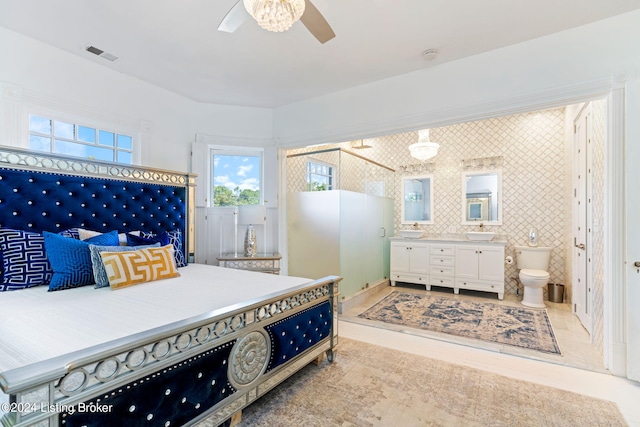 bedroom with sink, tile walls, and ensuite bath