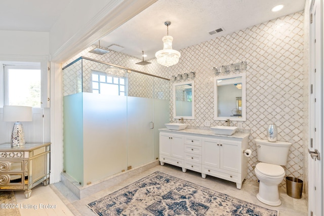 bathroom with walk in shower, tile patterned floors, toilet, tile walls, and vanity