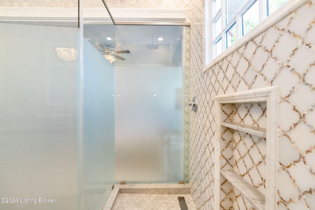 bathroom with tiled shower and ceiling fan