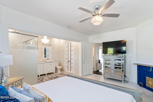 bedroom with sink, ensuite bath, and ceiling fan