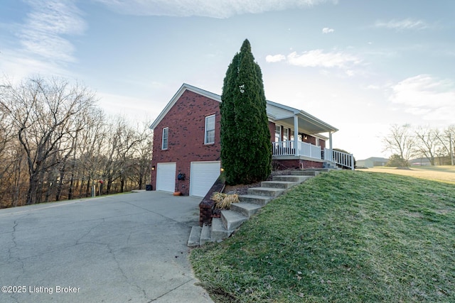 view of property exterior featuring a garage, a yard, and covered porch