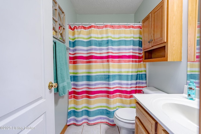 bathroom with toilet, a shower with curtain, a textured ceiling, vanity, and tile patterned flooring