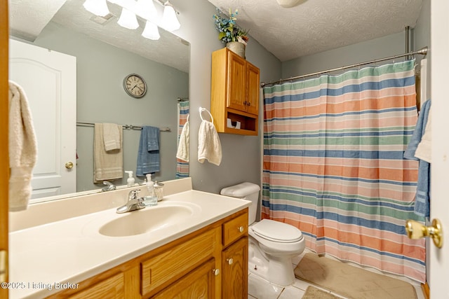 bathroom featuring vanity, toilet, curtained shower, and a textured ceiling