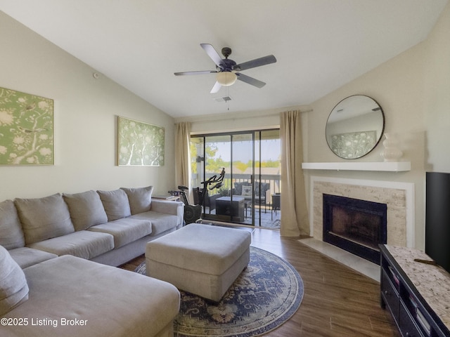 living room with dark wood-type flooring, ceiling fan, and vaulted ceiling