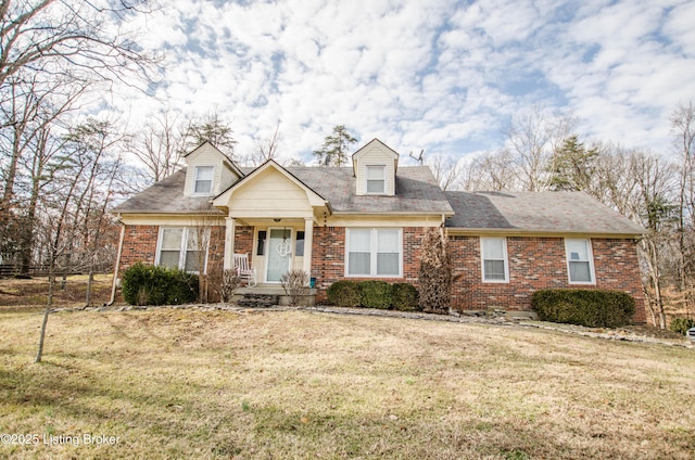 cape cod home featuring a front lawn and covered porch