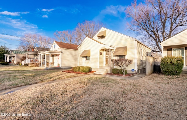 view of front of house featuring a front lawn and covered porch