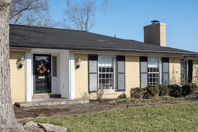 property entrance with a lawn