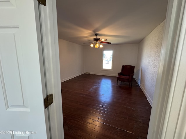 interior space with dark wood-type flooring and ceiling fan