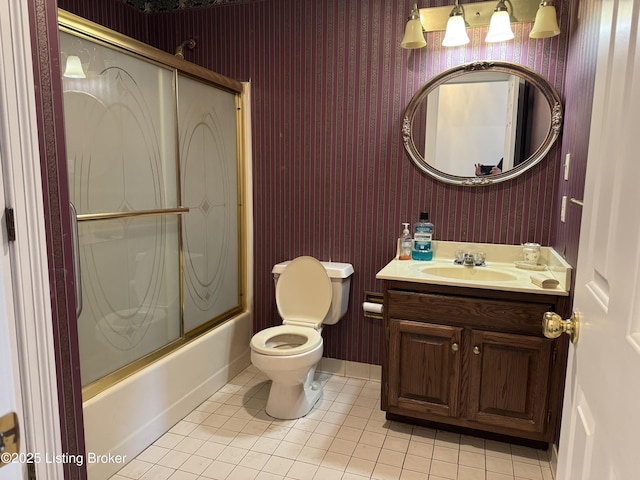 full bathroom featuring tile patterned floors, toilet, combined bath / shower with glass door, and vanity