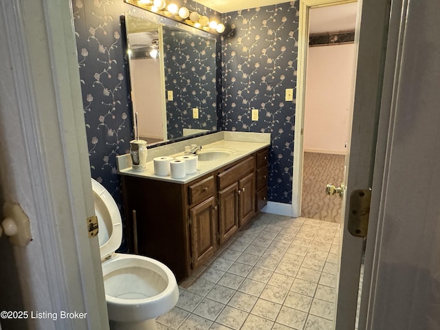 bathroom with vanity, tile patterned flooring, and toilet