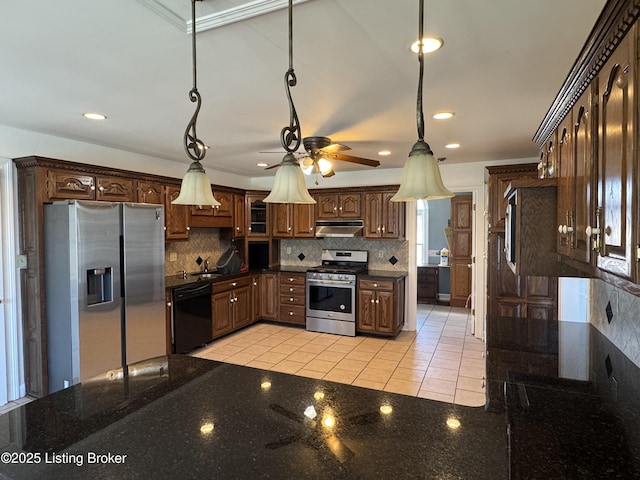 kitchen featuring backsplash, decorative light fixtures, and appliances with stainless steel finishes