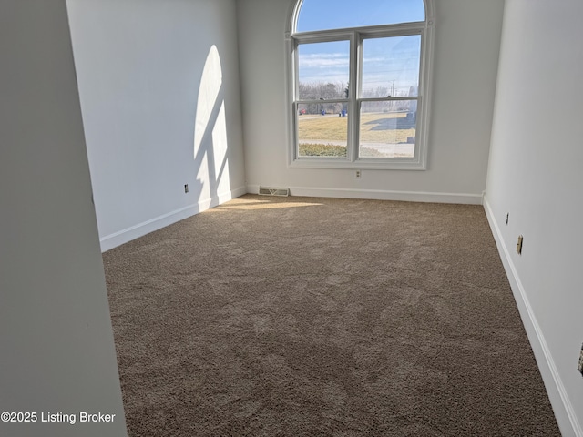 unfurnished room featuring carpet