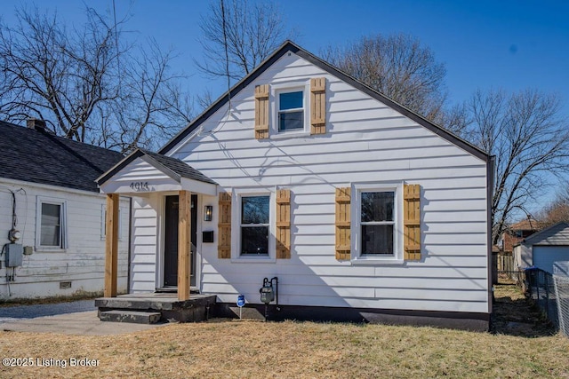 bungalow-style house with fence and crawl space