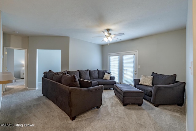 living room with light colored carpet and ceiling fan