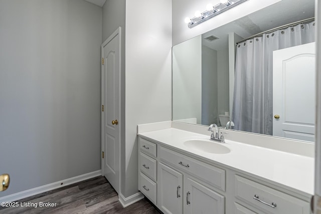 bathroom with vanity, hardwood / wood-style floors, and walk in shower