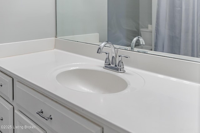 bathroom featuring vanity and toilet