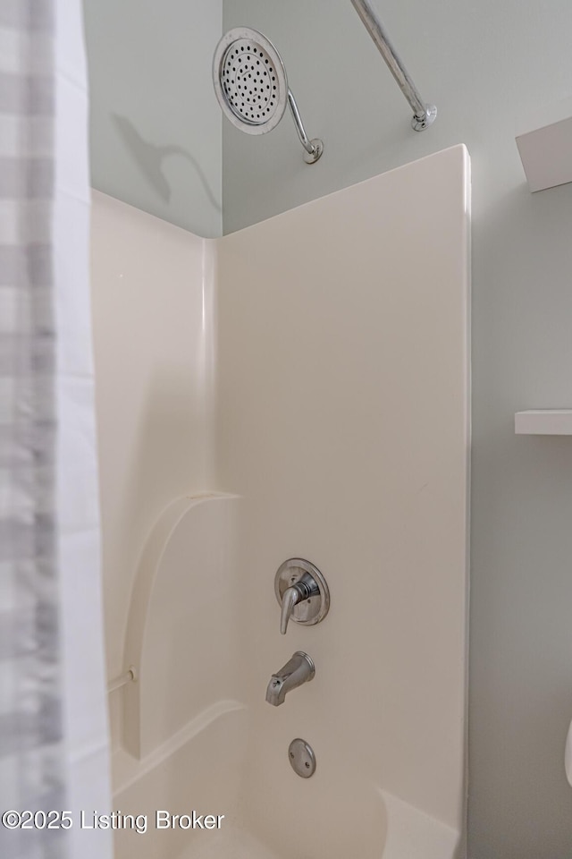 interior details featuring shower / bathtub combination