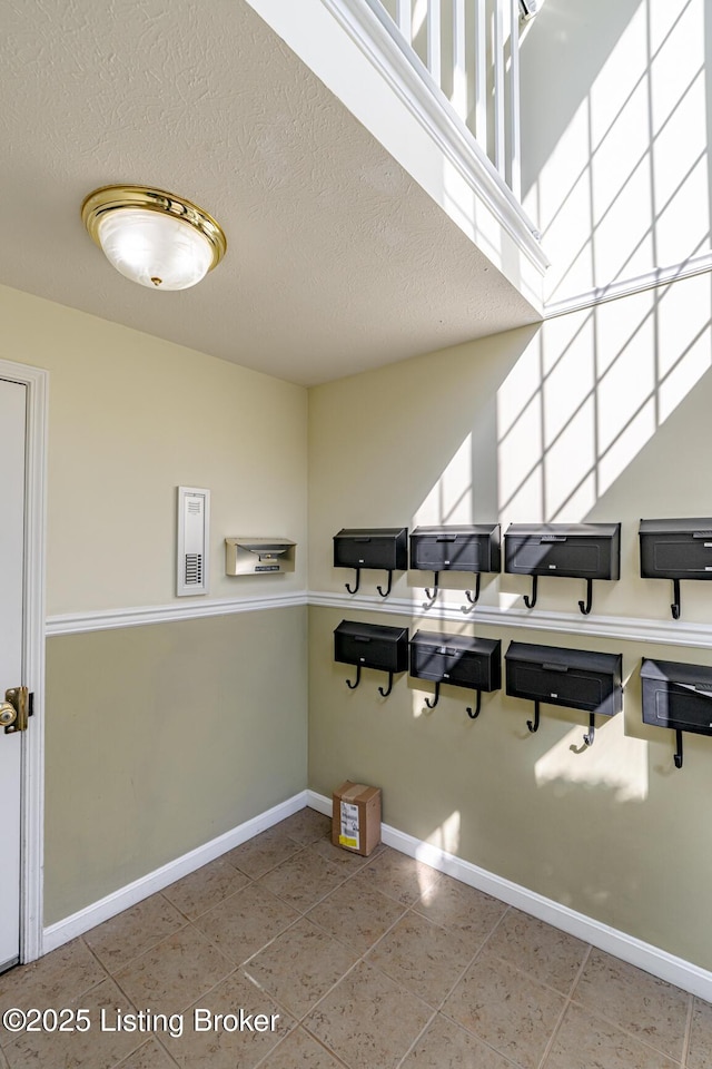 laundry area with a textured ceiling