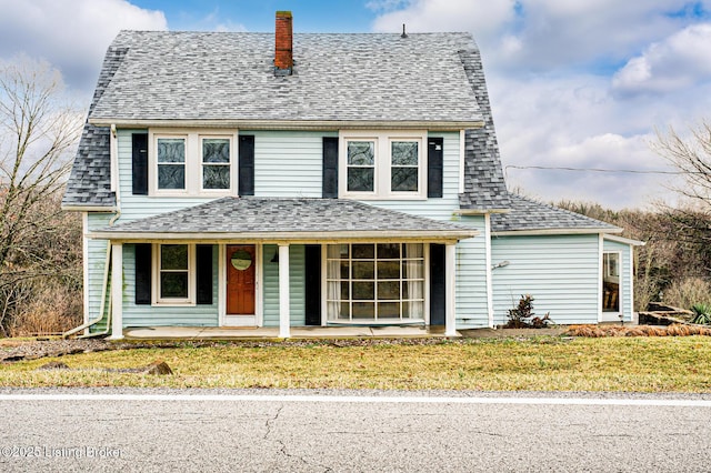 front of property with covered porch and a front lawn