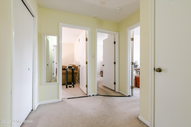 hall with carpet and baseboards